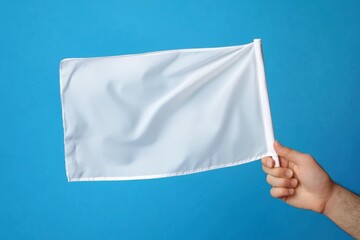 The striking blue background enhances the visual impact of the white flag.