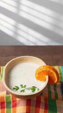 Vertical Video, Brukina, Degue, West Africa Africa Ghana Traditional drink, sweet, beverage made from millet milk and thick