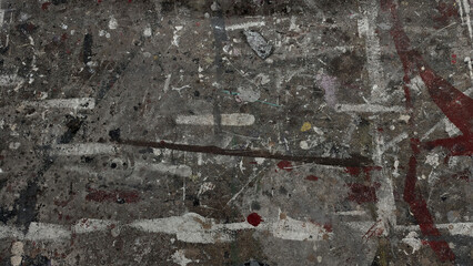 Urban textured surface street or wall heavily layered with dirty, abstract paint splatters and streaks. Dark gray background with muticolored lines