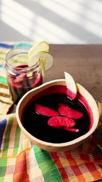 Vertical Video, Hibiscus Drink, Sobolo, Vibrant red drink made from dried hibiscus petals, pineapple peels, ginger, cloves, and sweetened to taste