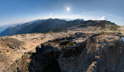 Sunlit Alpine Ridge Over a Vast Mountain Range in British Columbia, Canada, During Clear Sky
