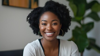 Fototapeta premium A woman smiling and speaking into a webcam, leading an online business meeting