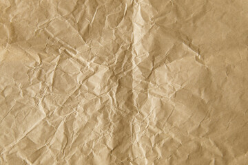 Obraz premium Crumpled brown paper texture with many wrinkles and folds.
