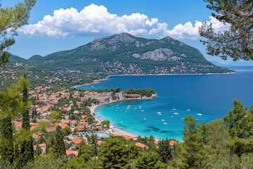 Obraz premium Panoramic view of coastal town, turquoise water, mountains