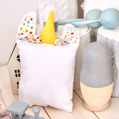 Whimsical handmade childrens toys plush pillow, wooden figurines, and vibrant colors.
