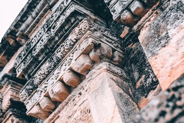 Ornate stone carvings adorn a weathered ancient structure