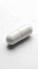 White Capsule Pill on White Background - Pharmaceutical Medication.