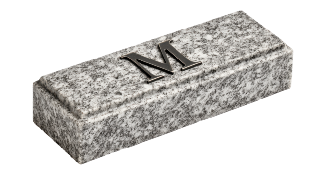 Granite Monogram Box: A detailed close-up of a sleek, granite box, emblazoned with a singular metallic initial. Its textured surface and elegant design evokes a sense of timeless quality.