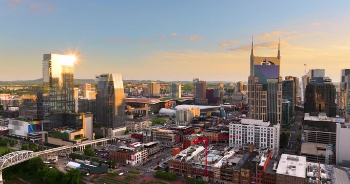 Downtown district of Nashville city in Tennessee, USA at sunset. Urban landscape of high-rise buildings in developing American metropolitan area.