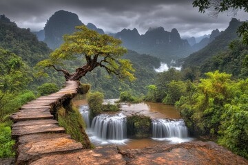 A weathered stone path leads to a waterfall cascading into a valley. A lone tree crowns the precipice. Misty mountains and lush greenery surround the scene