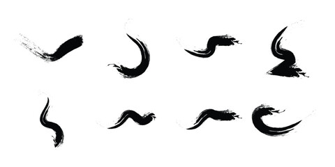 Collection of abstract black ink brush strokes and paint splatters on a white background