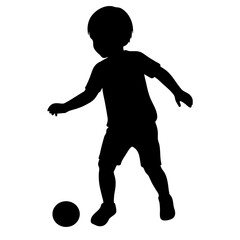 Silhouette of a boy playing soccer