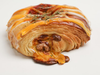 Savory pastry with mayonnaise drizzled on white background