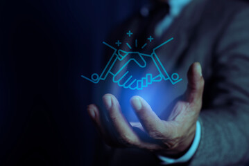 Trusted partner and business collaboration concept. Businessman holding handshake icon. Trustworthy collaboration and trusted partner. Trust in business relationships and financial investment.