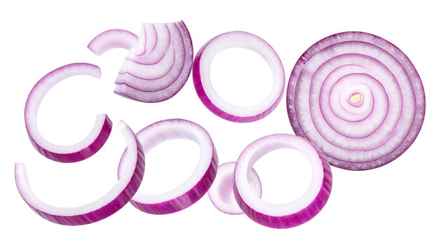 Thinly sliced red onion rings, some curved, isolated on black background