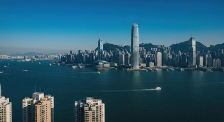 Obraz premium Panoramic view of a bustling waterfront city with many high-rise buildings under blue sky