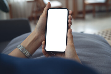 Cell phone blank white screen mockup. Woman hand holding, using mobile phone at home, empty space for social media marketing, mobile app design, business technology