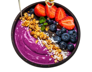 Vivid purple smoothie bowl topped with granola, berries, coconut, and a drizzle