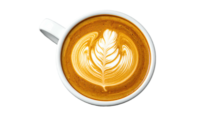 Overhead view of a white mug filled with coffee, artfully decorated with a leaf design