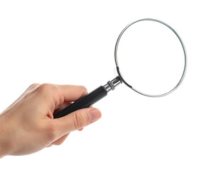 A human hand holds a magnifying glass against a black background, isolated