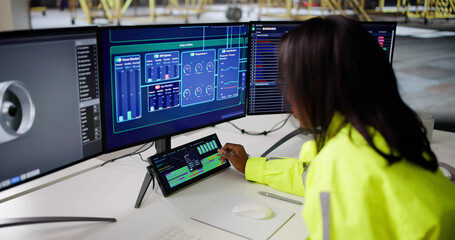 African American Woman Monitors SCADA System