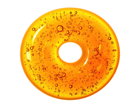 Close-up of a translucent golden ring shape with bubbles, against a black background