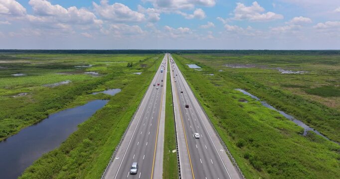 Section of rural I-75 near Gainesville city in Florida surrounded by swampy wetlands and traffic moving in both directions.