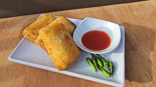 bread and butter,Risole,Rissoles,Risol is snack fiiled with vegetables,smoked beef,sausage,cheese,mayonnaise sauce,wrapped in risol skin and bread crumbs served with green cayenne pepper and chili sau