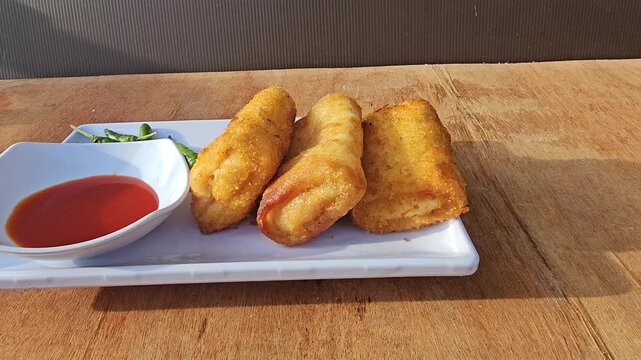 fried chicken wings Risole,Rissoles,Risol is snack fiiled with vegetables,smoked beef,sausage,cheese,mayonnaise sauce,wrapped in risol skin and bread crumbs served with green cayenne pepper and chili 