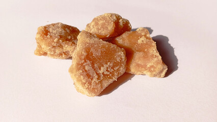 Jaggery brown sugar cubes. Sugar can jaggery on isolated white background