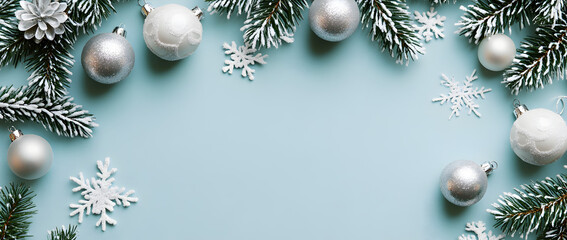 Christmas background with white and silver decorations on a light blue surface, a flat lay composition, top view.