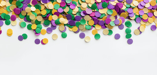 Colorful confetti for Mardi Gras celebration on white background, copy space