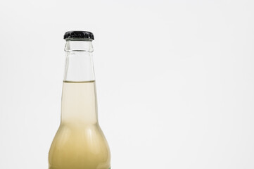 Close-up of a bottle with a clear liquid and black bottle cap.