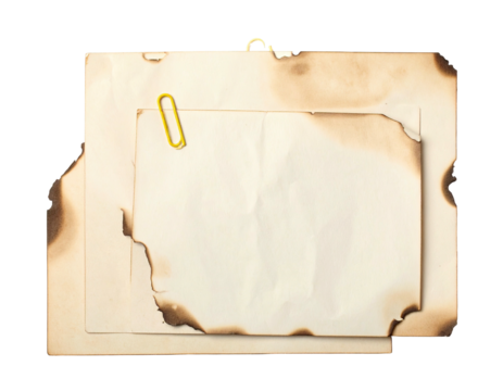 Overlapping, burnt paper sheets, yellow clip, aged appearance on isolated background