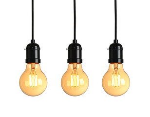Three vintage light bulbs hanging against a black background, lit up and glowing