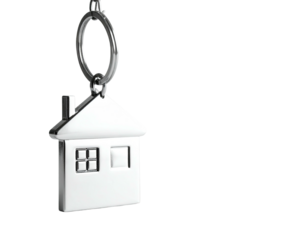 Silver house-shaped keychain suspended against a black background