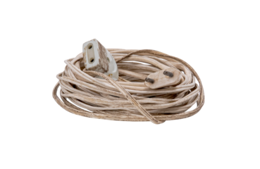 Dirty, coiled white electrical cable with plug and socket.