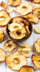 Dried apple slices in a bowl on a white surface