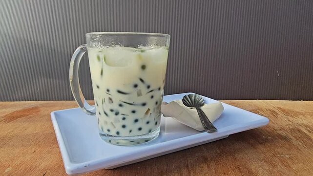 glass of milk,Cendol is an iced sweet dessert contains pandan flavored green rice flour jelly,coconut milk and pandan sugar,additional toppings are dinced jackfruit,red bean,durian.Javanese called Daw