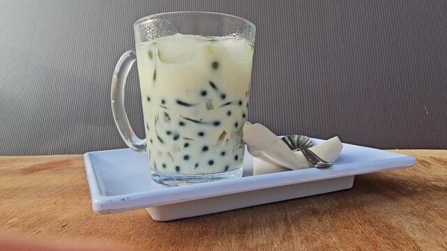 glass of milk,Cendol is an iced sweet dessert contains pandan flavored green rice flour jelly,coconut milk and pandan sugar,additional toppings are dinced jackfruit,red bean,durian.Javanese called Daw