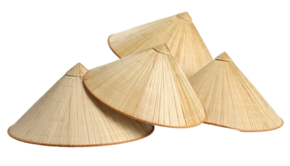 Four stacked straw conical hats on a black background, close up