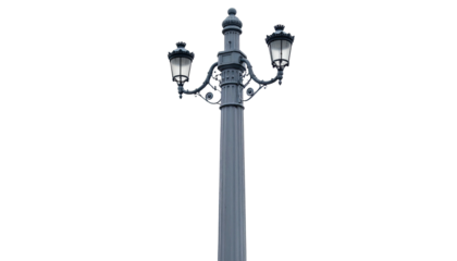 Ornate two-headed streetlamp with lit globes against a black background