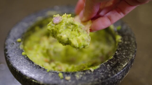 dipping chips in fresh guacamole