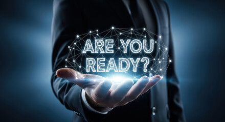 Are You Ready? Businessman holding futuristic text. Concept for business, innovation, technology, leadership, future, success, and preparation.