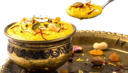 Rich, golden dessert in a decorative bowl with a spoon, garnished with nuts