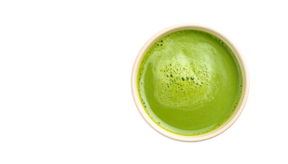 A top view of a frothy green matcha tea in a white cup.