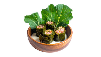 Close-up view of stuffed rolls in a bowl, surrounded by greens, over creamy sauce