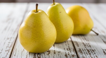 Three Ripe Yellow Pears on Rustic White Wooden Table.