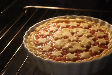 Close-up of raw homemade decorated peach pie or tart ready to bake in the oven