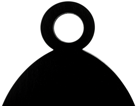 Silhouetted shape with a circular handle on top, against a stark black backdrop